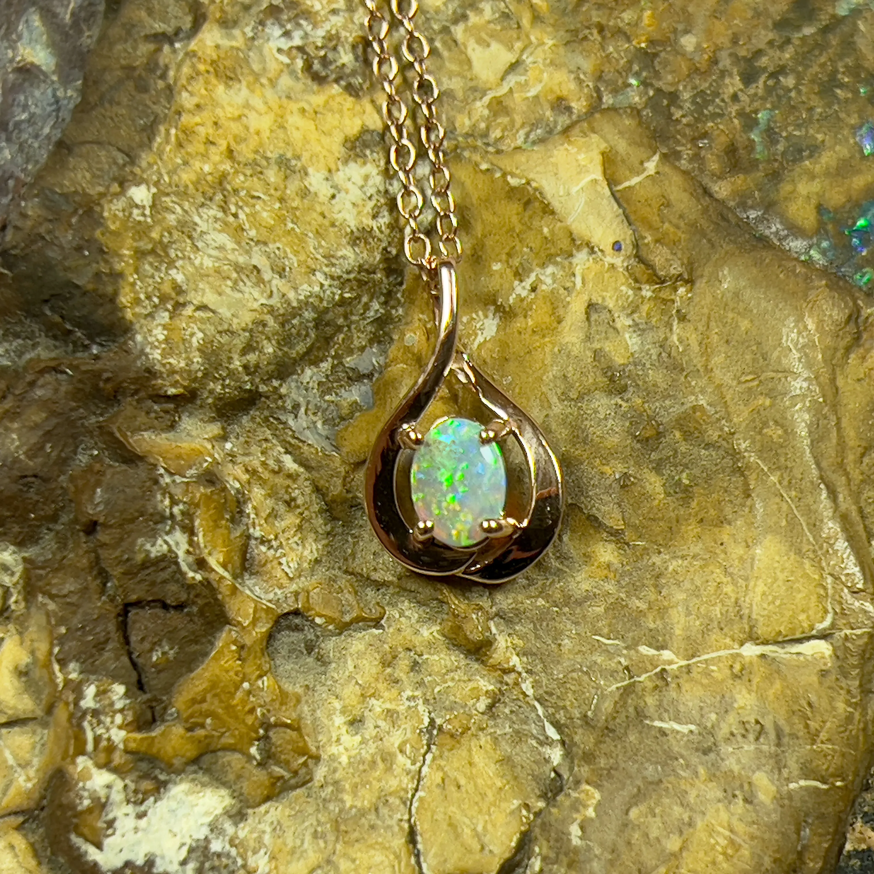 14kt Rose Gold swirl pendant with one Black Opal 0.33ct