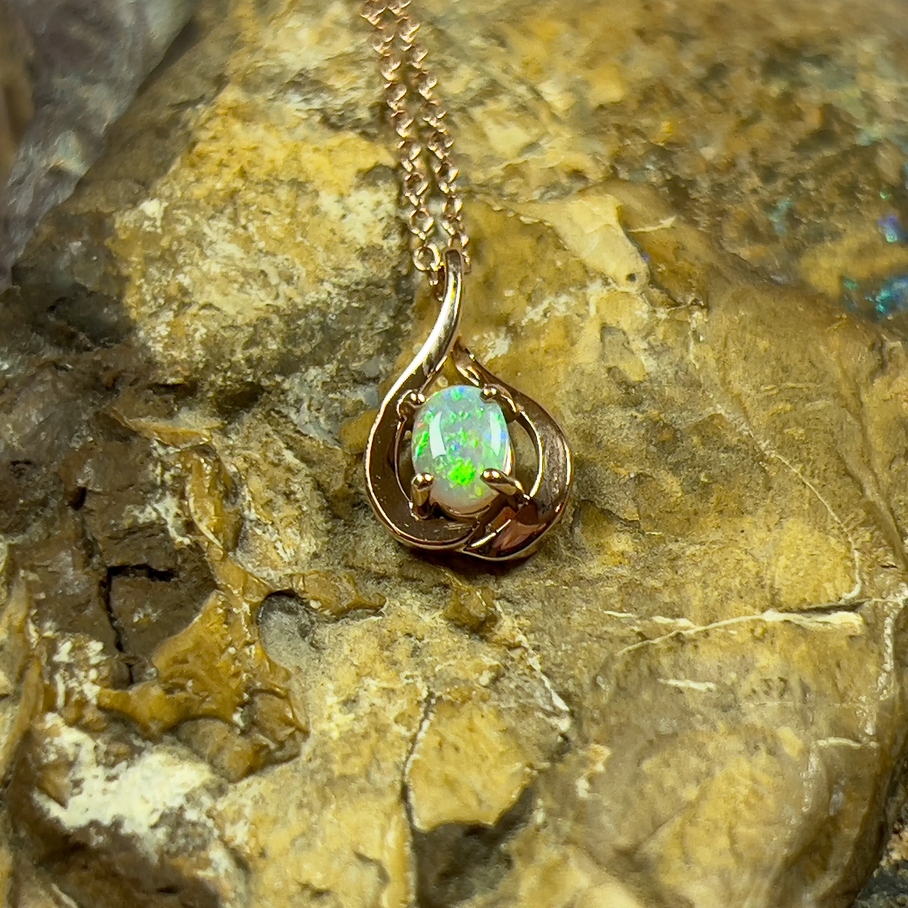 14kt Rose Gold swirl pendant with one Black Opal 0.33ct