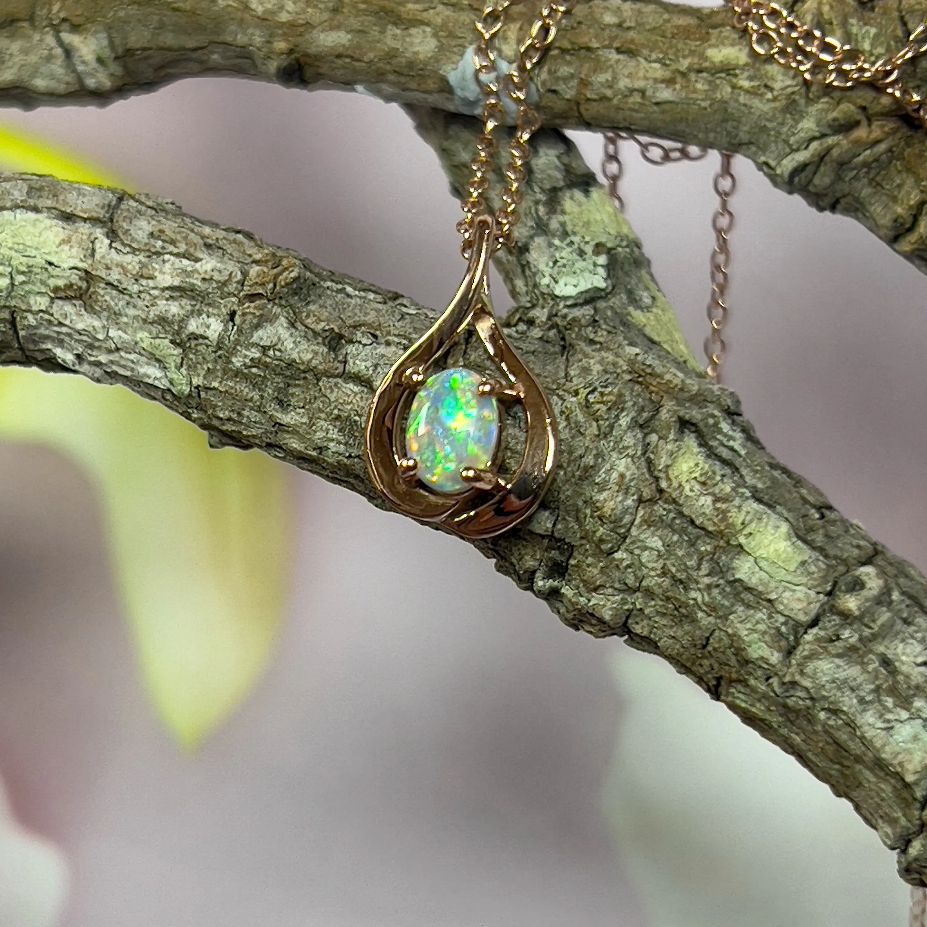 14kt Rose Gold swirl pendant with one Black Opal 0.33ct