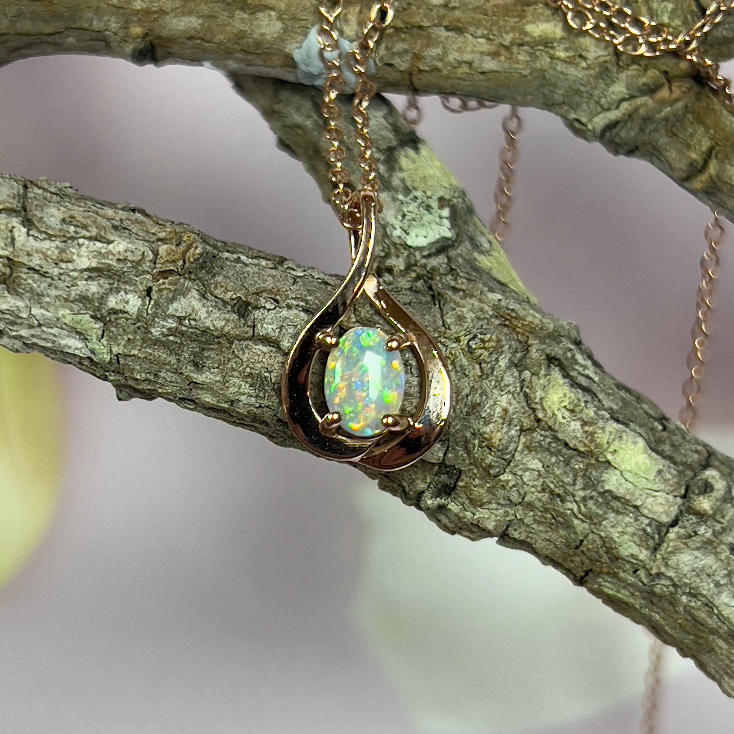 14kt Rose Gold swirl pendant with one Black Opal 0.33ct