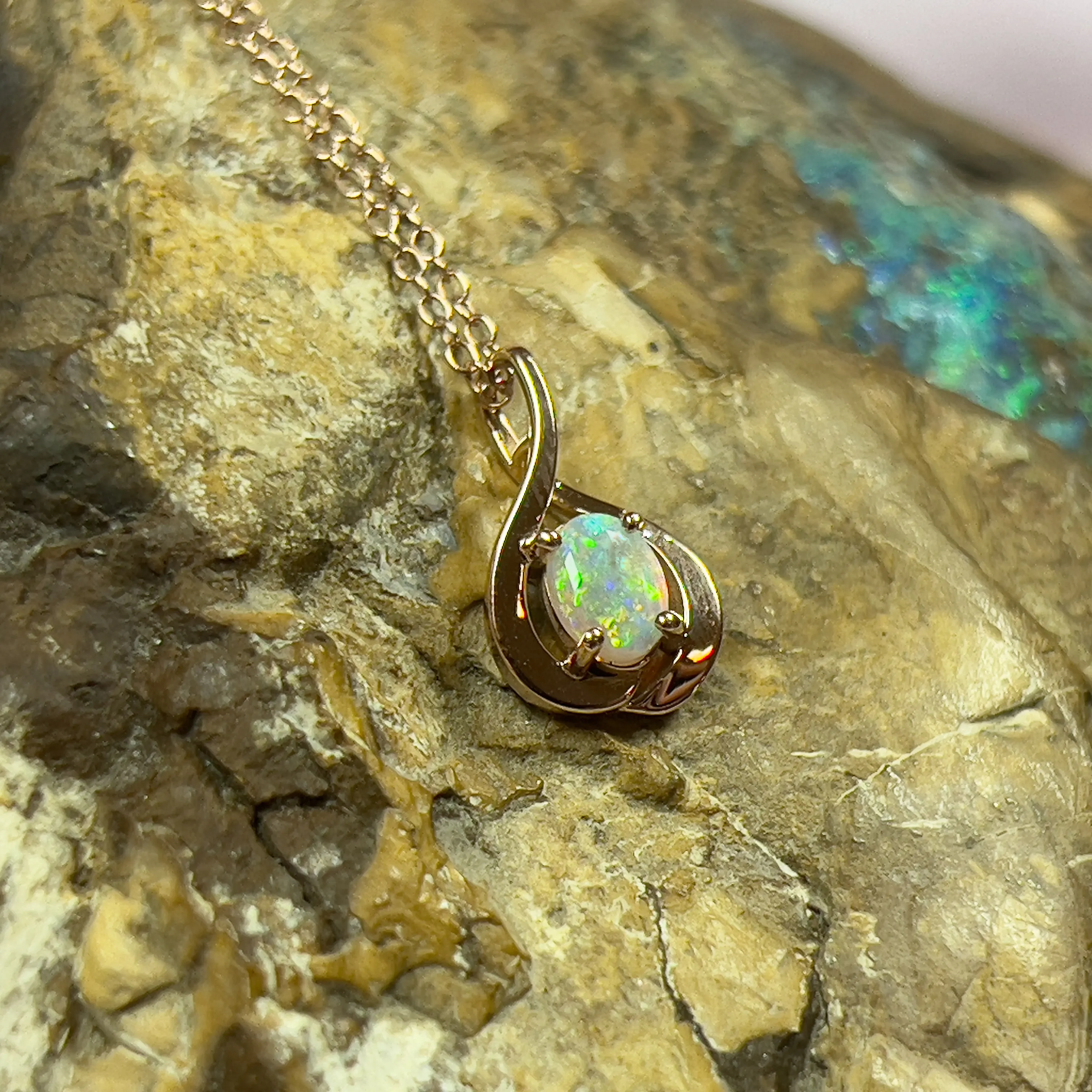 14kt Rose Gold swirl pendant with one Black Opal 0.33ct