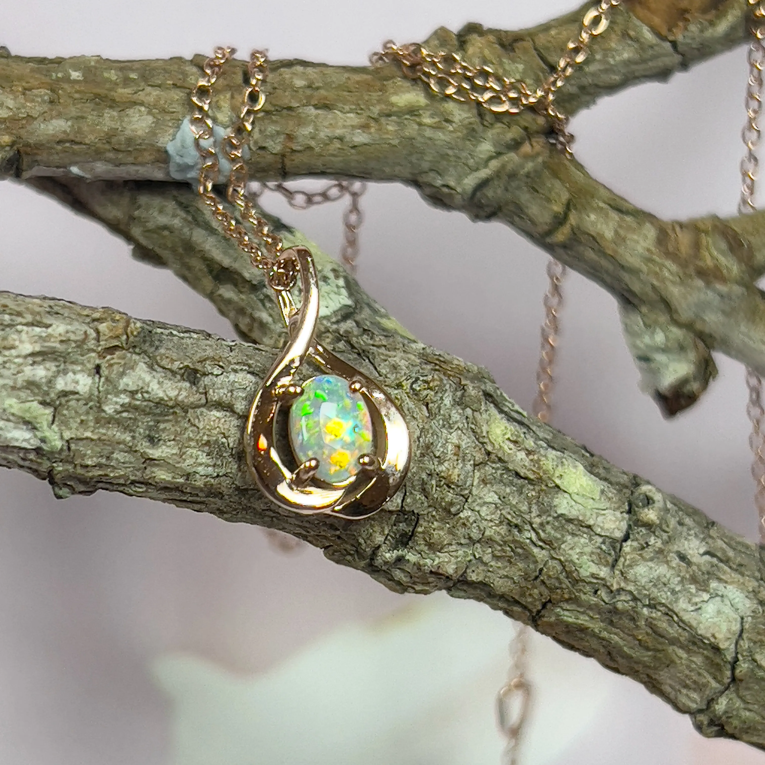 14kt Rose Gold swirl pendant with one Black Opal 0.33ct