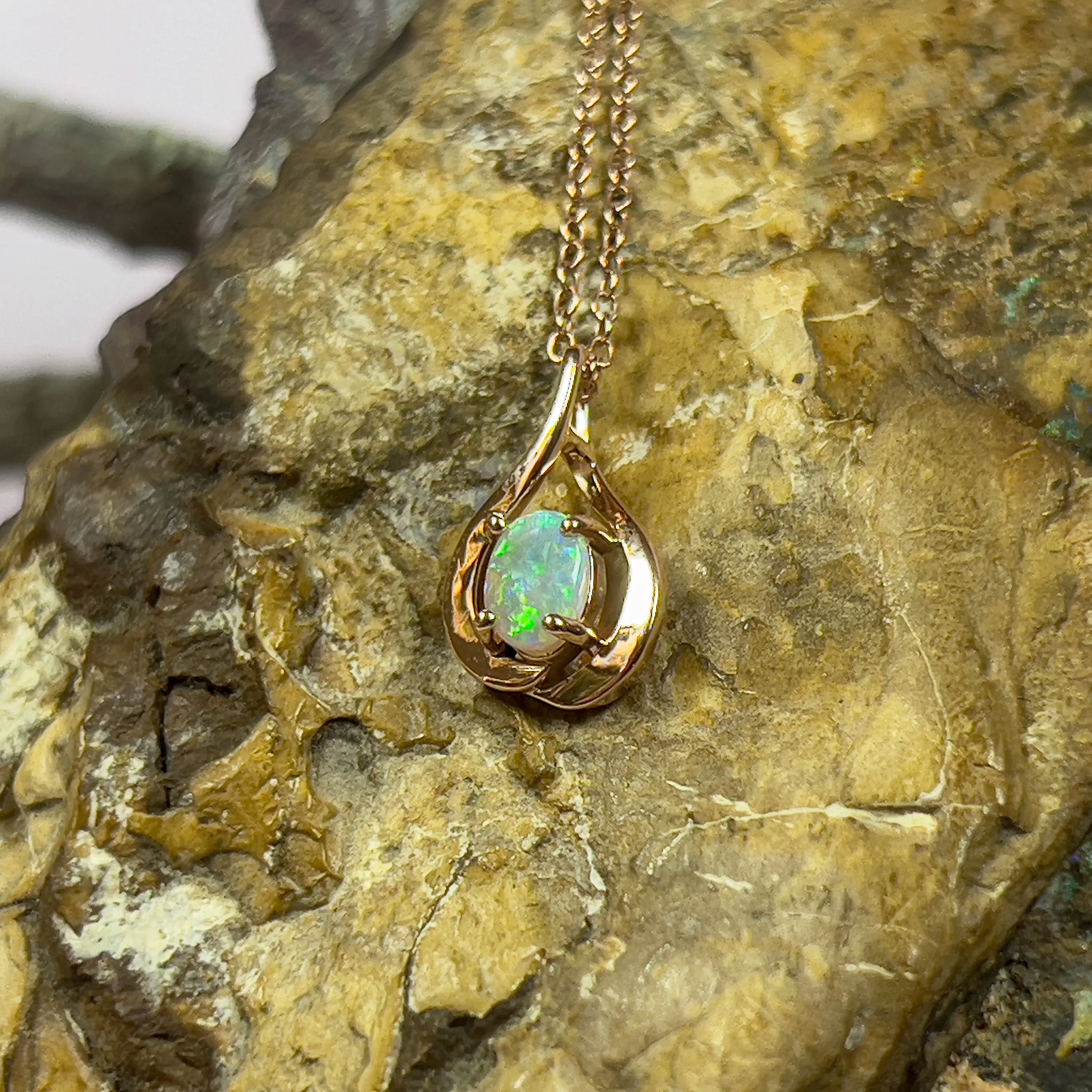 14kt Rose Gold swirl pendant with one Black Opal 0.33ct